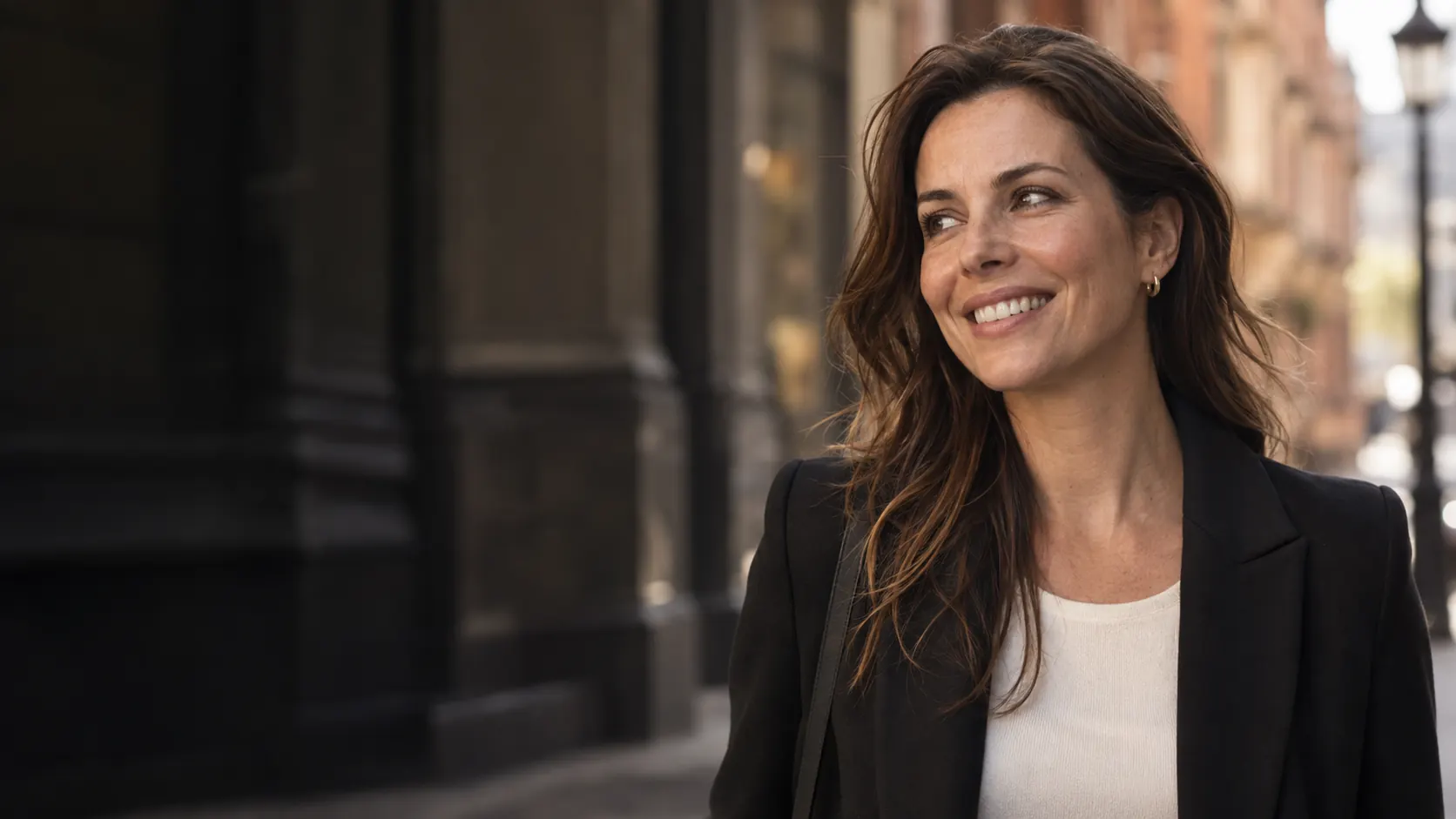 Illustrative campaign portrait of a woman smiling on a London street; not a patient photograph.